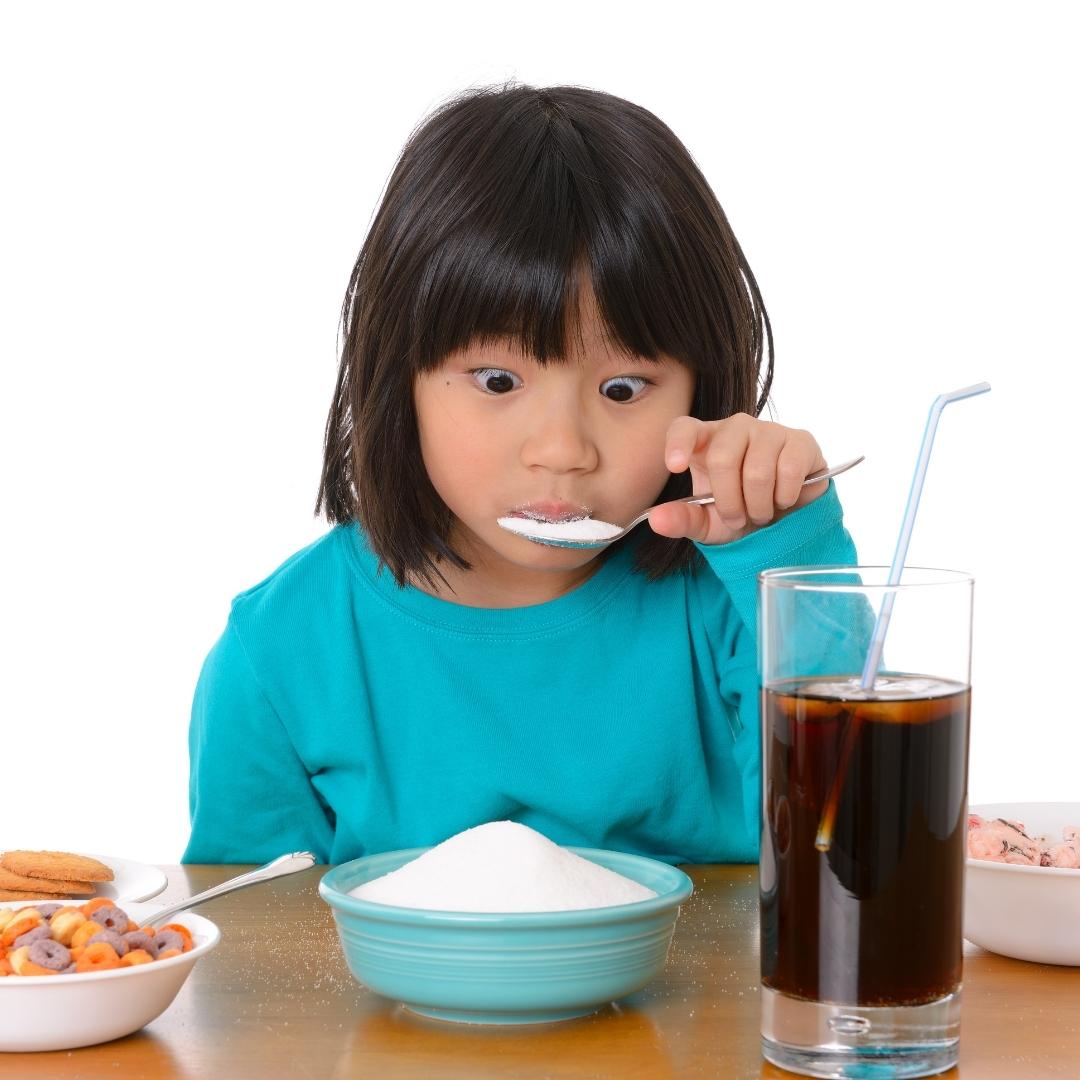 little girl eating tons of sugar