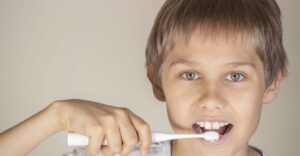 A young boy brushing his teeth
