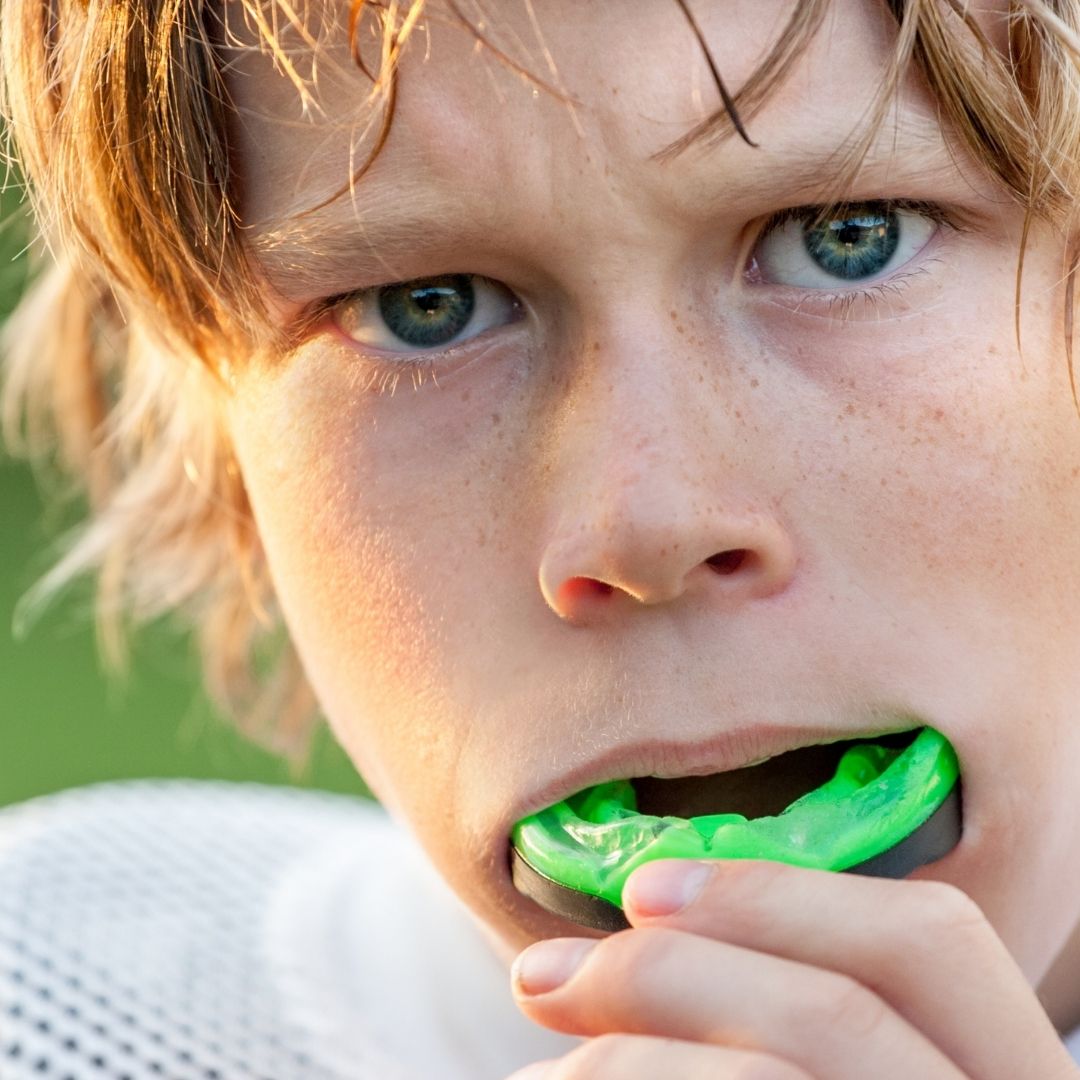 child inserting mouth guard